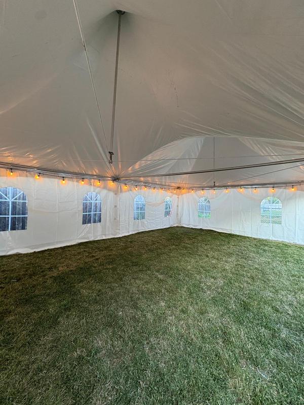 Inside a Skytop tent with warm string lights overhead