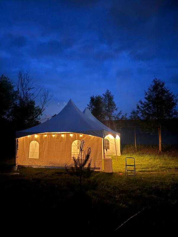 Round-top tent lit warmly at night