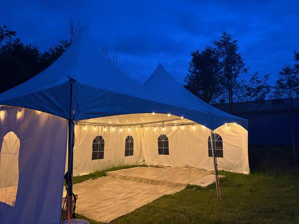 Tent with full sidewalls glowing at night