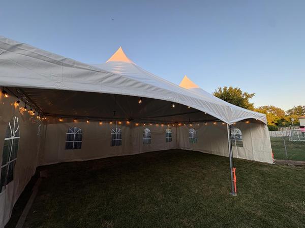 Skytop tent exterior with string lights at twilight