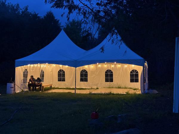 Two Skytop tents lit up at night for an evening event
