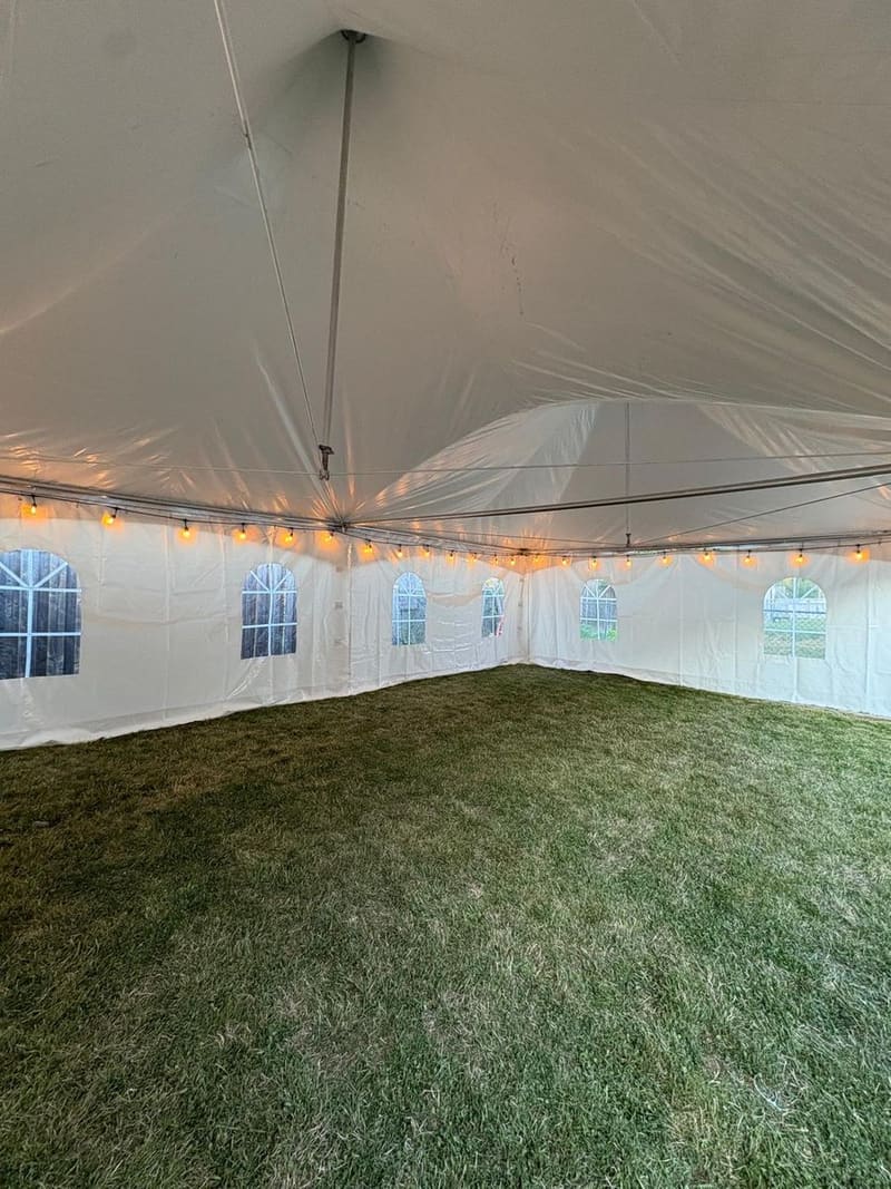 Inside a Skytop tent strung with warm string lights, ready for an evening function